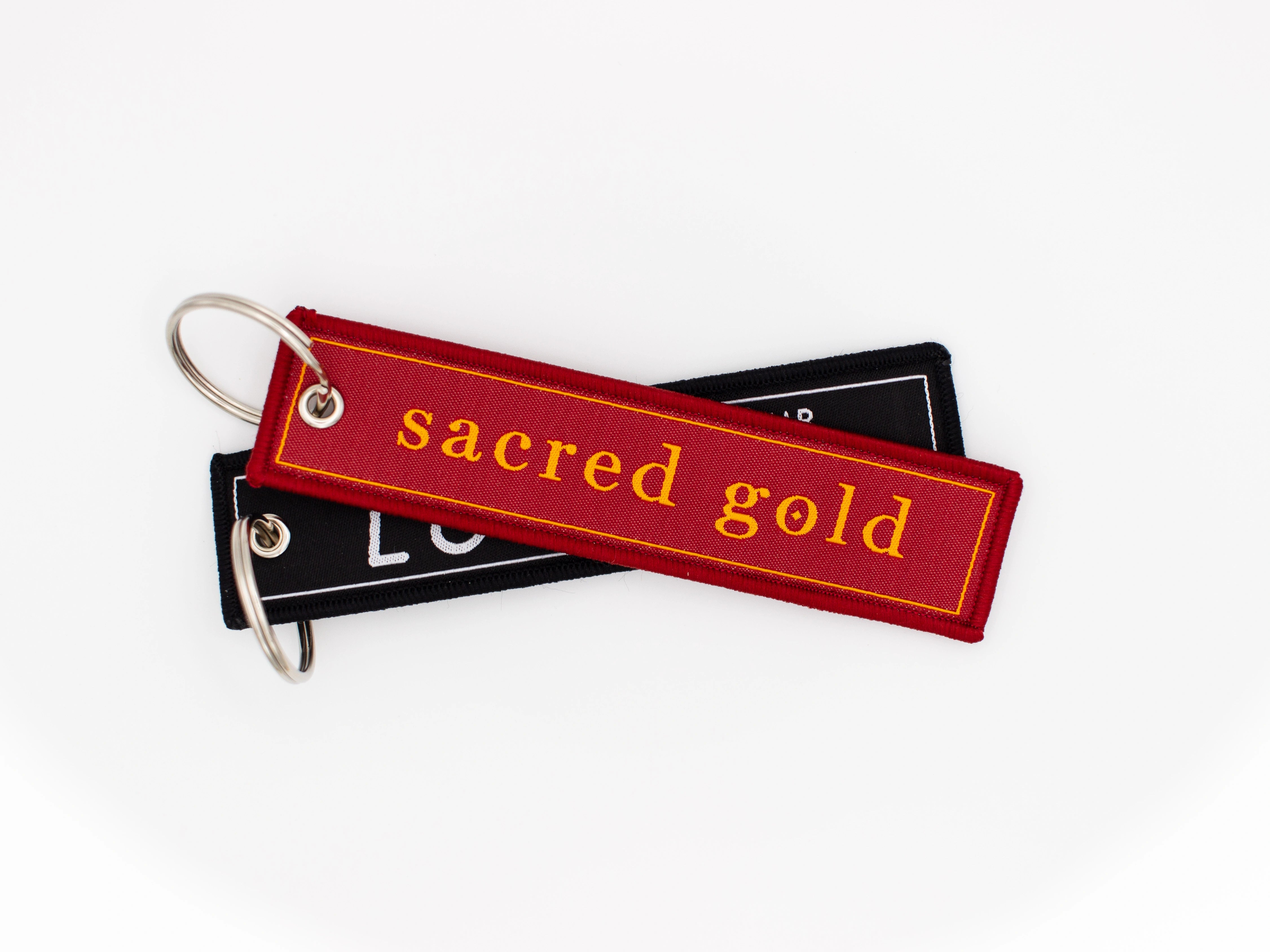 red and Black Sacred Gold keyrings 