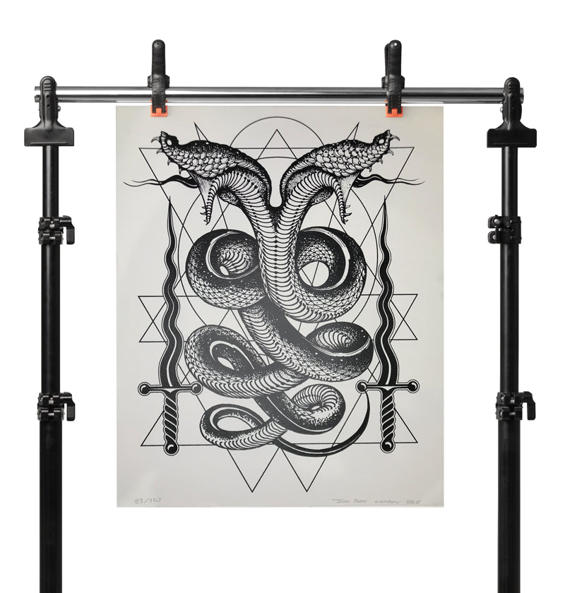 Black emperor two-headed serpent. Print by Joao Bosco hung up on a stand
